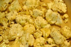 cauliflower and garlic in pan for roasting