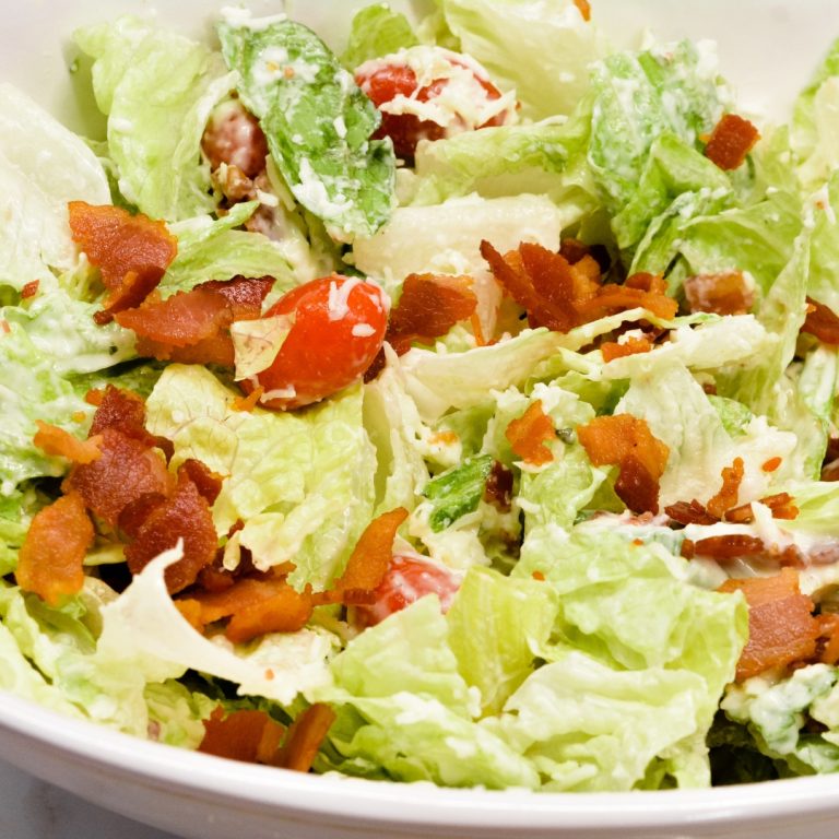 BLT salad is a simple salad recipe combining lettuce, tomatoes, mozzarella cheese, and bacon crumbles with a homemade creamy dressing that is a cross between ranch and caesar dressing.