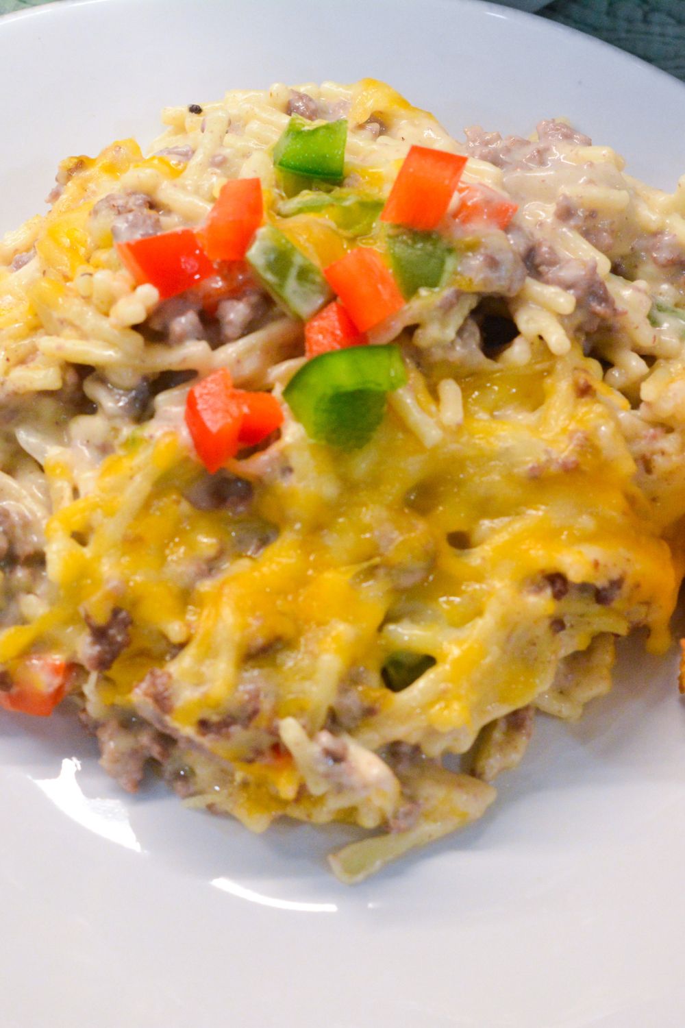 Cheesy and comforting, this Creamy Hamburger Spaghetti Casserole is the perfect weeknight dinner. Made with ground beef, spaghetti, cream cheese, and Colby-Jack cheese, it's easy and delicious!