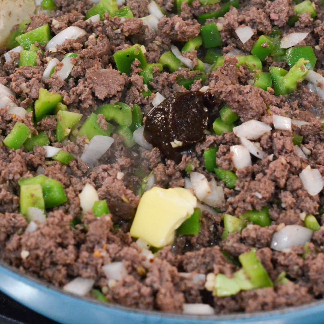 Stir in the butter until melted. Then add the flour and stir to completely blend into the beef and vegetables. Slowly add the beef broth and milk, stirring as you add. 