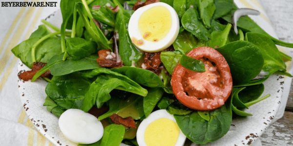 Spinach salad with hot bacon dressing is an easy spinach salad recipe made with bacon, tomatoes, and eggs tossed in a warm dressing that has a mixture of tangy sweetness and salty from the bacon. #bacon #spinach #salad #bacon #BaconDressing #SpinachSalad #EasterRecipes #keto