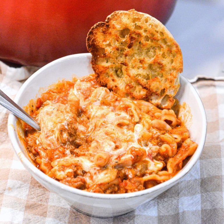 Lasagna soup recipe with ricotta is made with ground pork or beef, Italian seasonings, your favorite pasta, and topped with cheese.