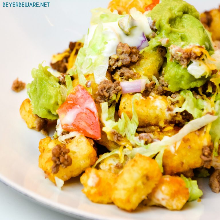 Totchos are the tater tot version of nachos with all your favorite taco toppings like ground beef, lettuce, tomatoes, and cheese.