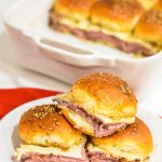 Roast Beef Hawaiian Roll Sliders, also known as Sandy's Sandwiches, combine butter, garlic powder, Worcestershire sauce, and poppy seeds for a butter glaze that complements these baked roast beef and cheese sandwiches. These sandwiches are easy to make in 10 minutes and bake for 20-25 minutes.