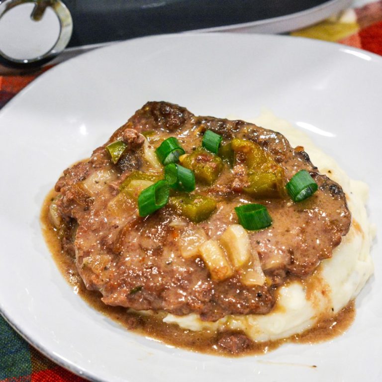 Easy Crock Pot Beef Cubed Steaks with Gravy recipe! Tender beef cube steaks cooked in a slow cooker with French onion soup, cream of mushroom soup, and vegetables. Serve over mashed potatoes for a comforting and delicious meal.