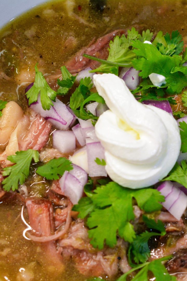 Combined with hot green chiles like Jalapenos, poblanos garlic, onions, and cilantro, you get an unbelievably bright, vibrant green sauce that's deliciously tangy and packed full of roasted, spicy flavor for the ultimate crock pot smoked pork chile verde.