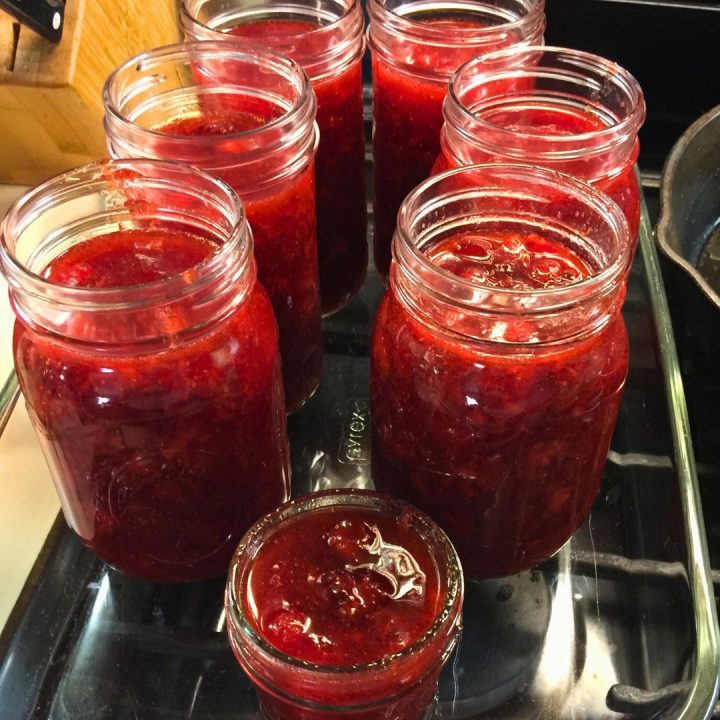 Then, ladle the jam into clean, sterilized mason jars, leaving a 1/2-inch space at the top to expand during freezing. You can use pint or half pint jars. Seal the jars tightly with lids.