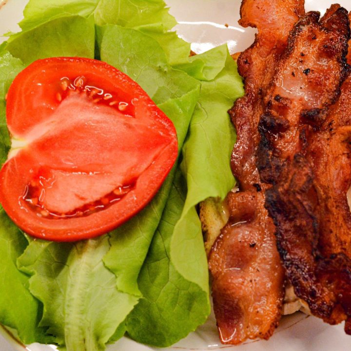 Add Bacon, Lettuce, and Tomato: Top the bread spread with chipotle mayo with leaf lettuce, crispy fried bacon, and sliced tomatoes.