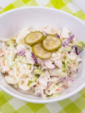 The creamy Dill Pickle Coleslaw recipe is made with shredded cabbage, pickles, pickle juice, and mayonnaise.