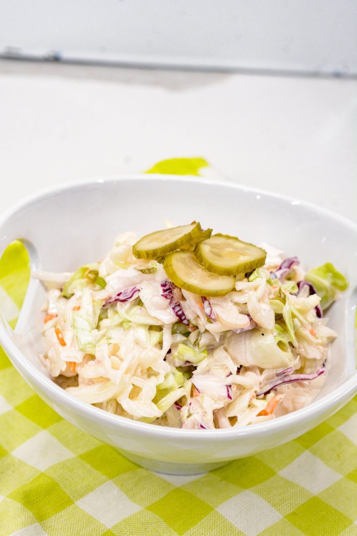 The creamy Dill Pickle Coleslaw recipe is made with shredded cabbage, pickles, pickle juice, and mayonnaise.