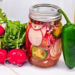 These refrigerator spicy pickled radishes are an easy pickled radish recipe made with fresh radishes, jalapenos, red onions, white wine vinegar, salt, sugar, and spices.