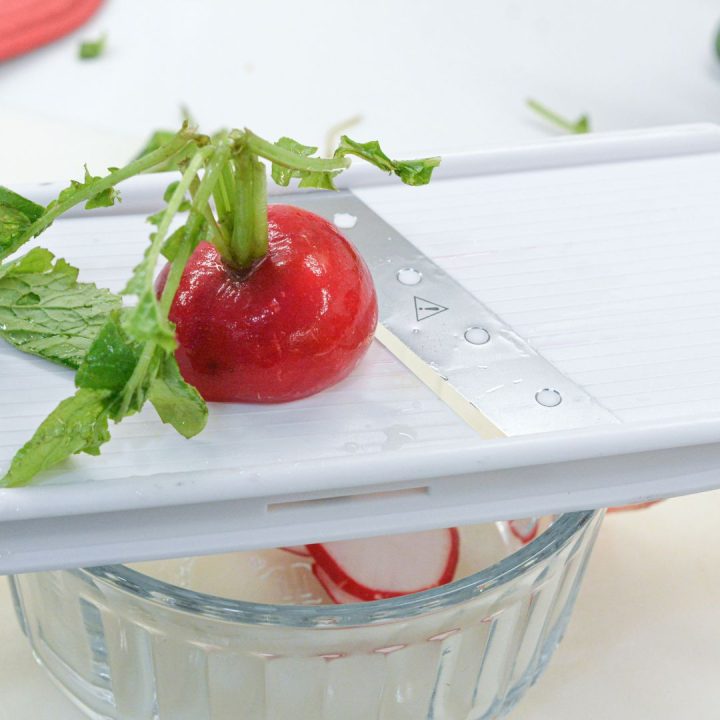 Slice the radishes thinly using a mandoline or a sharp knife. If your radishes are particularly large, consider cutting them in half before slicing to ensure even pickling.