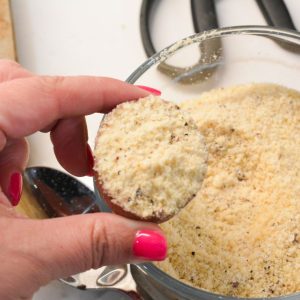 Toss the potato halves in avocado oil. Then dip the cut edge into the Parmesan mixture, ensuring each piece is evenly coated.