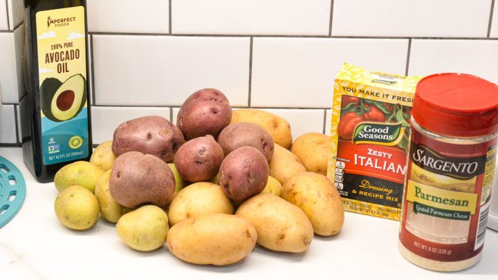 Parmesan Crusted Potatoes Ingredients are baby potatoes, grated parmesan cheese, Italian dressing seasoning mix and avocado oil