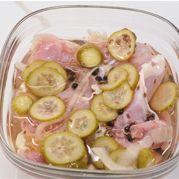 Brine the Chicken: Place the chicken in a large bowl or bag with the brine of pickle juice, pickles, onions, garlic, peppercorns, and olive oil. Make sure the chicken is fully submerged in the liquid. 