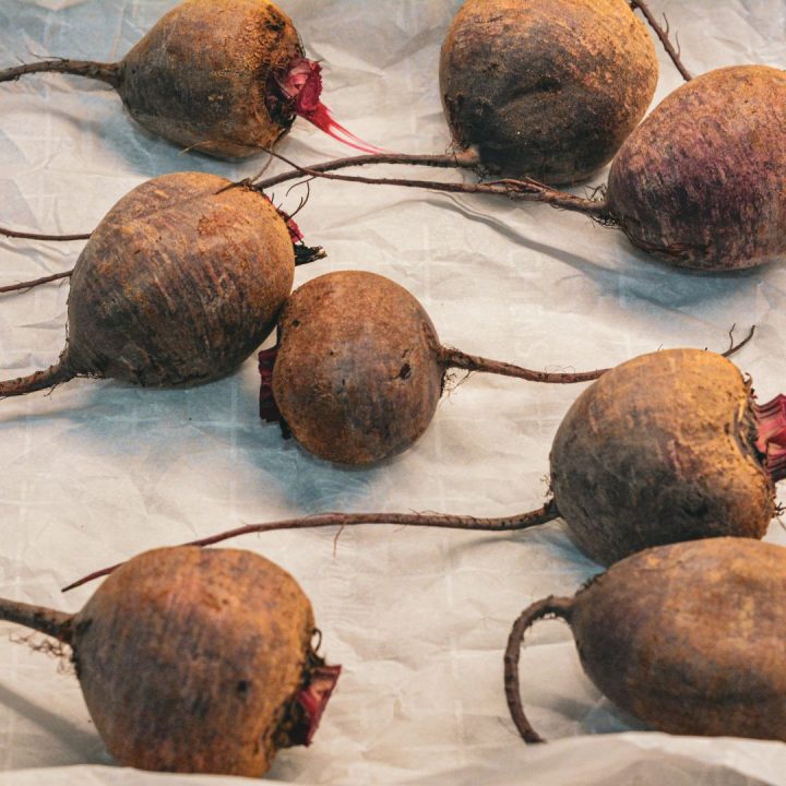 Wash the beets thoroughly to remove any dirt. Trim the beet greens, leaving about an inch of the stems to prevent bleeding. You can either leave the beets whole or cut them into halves or quarters for faster roasting.