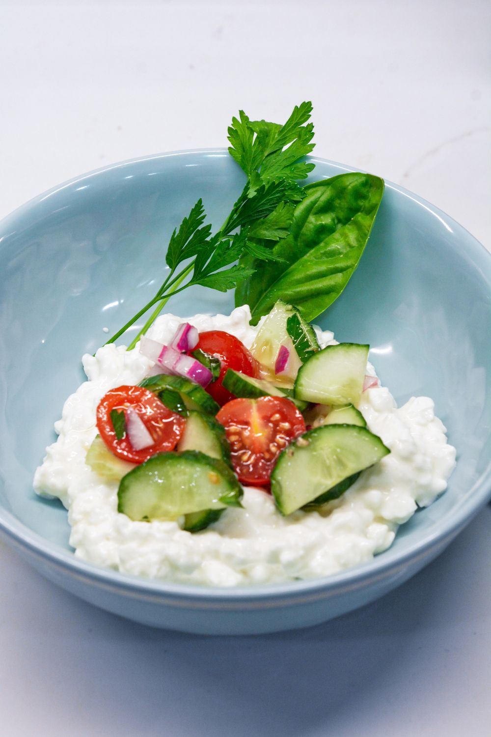 Cucumber and tomato salad is the perfect summer salad with homemade dressing that can be a high protein cucumber, tomato, and onion salad with cottage cheese.