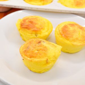 Create the high-protein egg bites with cottage cheese for an easy high-protein breakfast all week long by using a silicone muffin pan with pureed cottage cheese, eggs, bacon, and cheese.