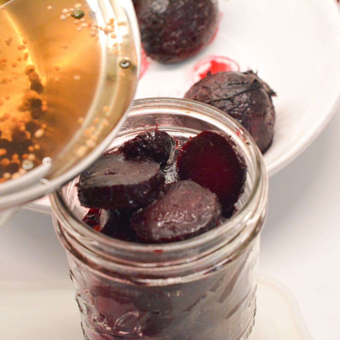 Carefully pour the hot pickling brine over the beets, ensuring that the beets are fully submerged. Leave a little headspace at the top of the jars.