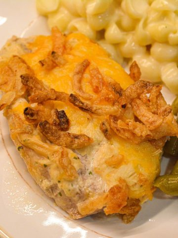 Discover an easy and delicious recipe for easy oven baked pork chops topped with ranch, Colby Jack cheese, and crispy French fried onions.