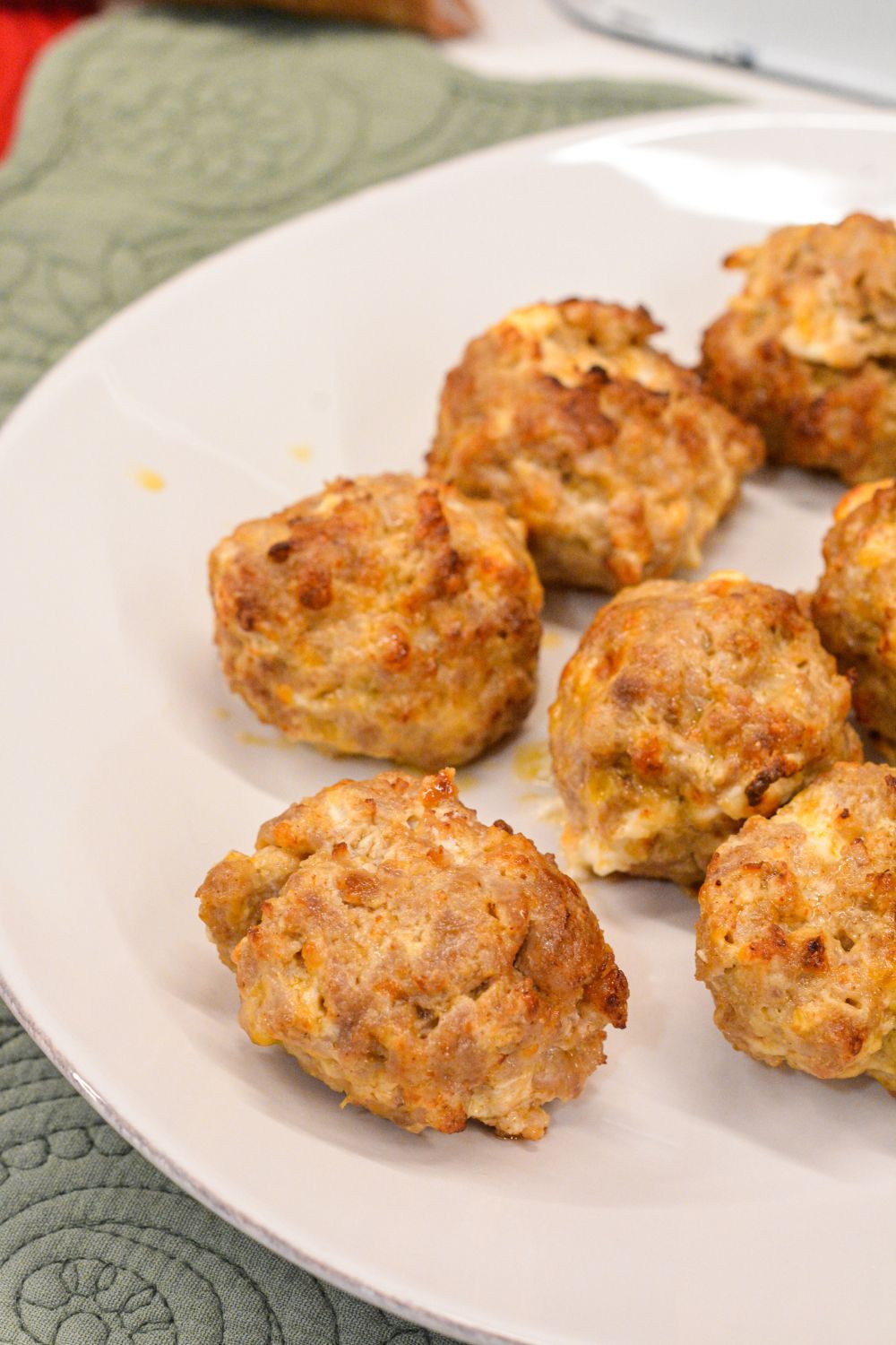 Make these delicious Air Fryer Sausage Balls with ground pork, cream cheese, Colby Jack, Parmesan, and breakfast sausage seasoning for a quick and high protein breakfast.