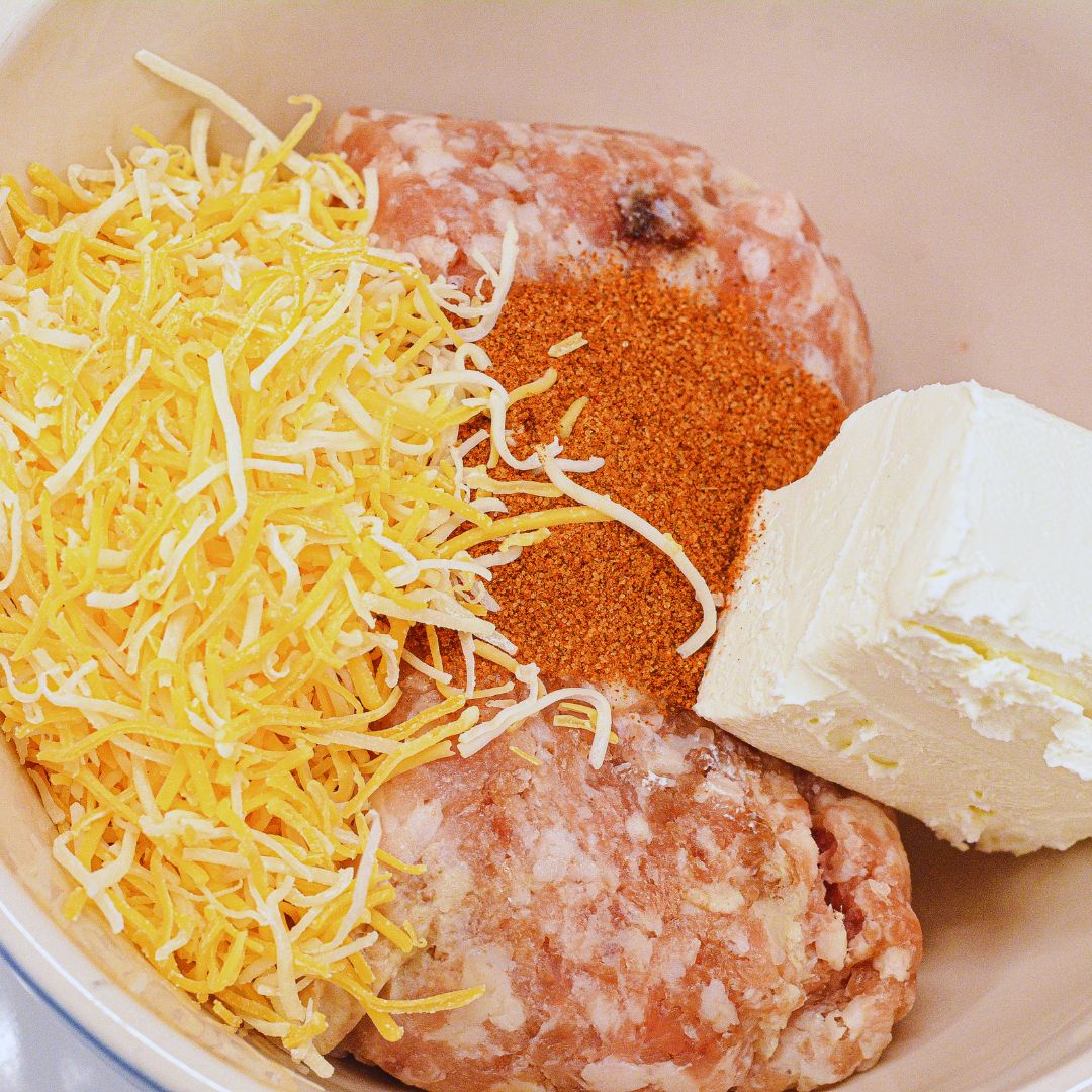 Mix the ingredients: In a large mixing bowl, combine the ground pork or sausage, cream cheese, Colby Jack cheese, Parmesan cheese, and breakfast sausage seasoning. Use your hands or a spatula to thoroughly mix until everything is well combined.