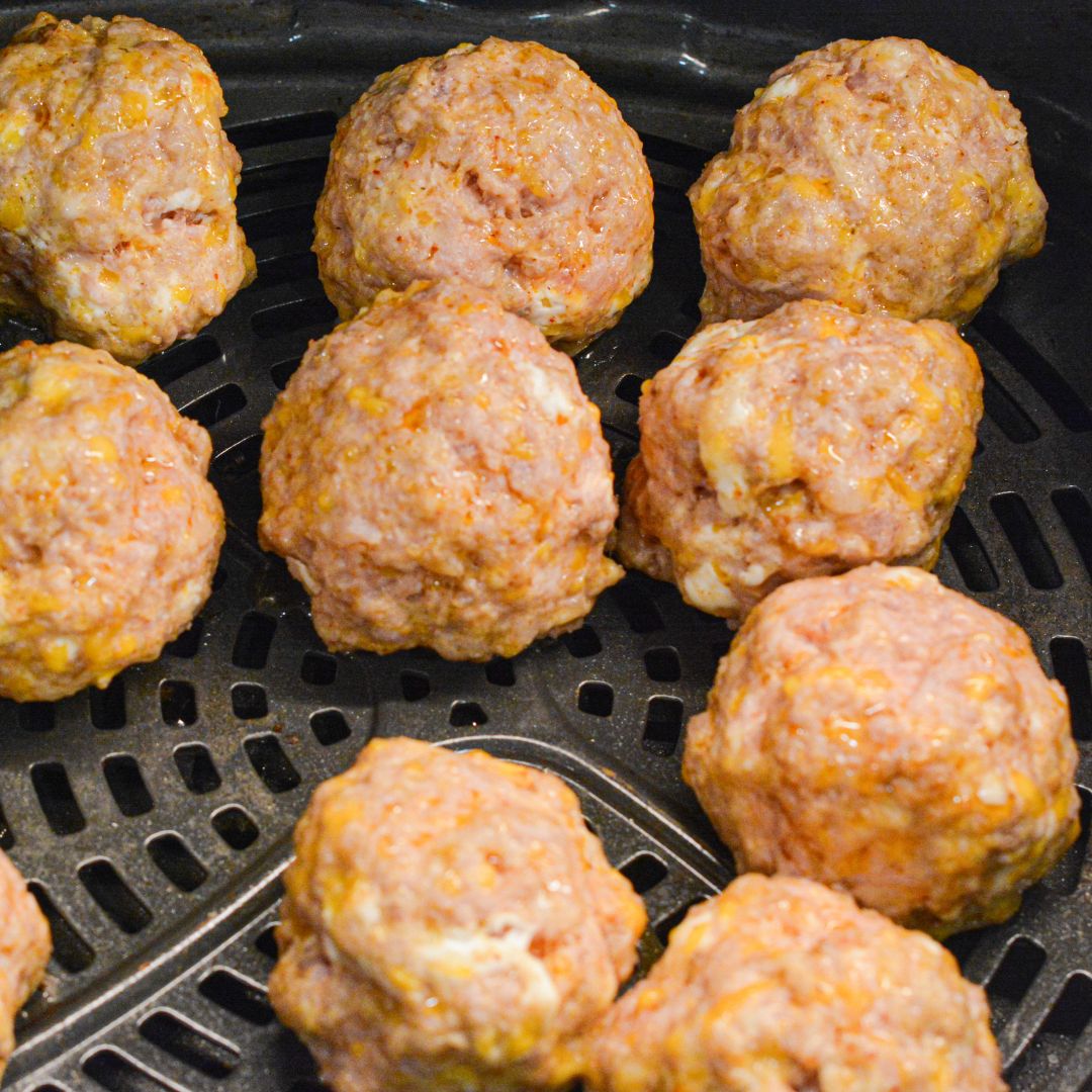 Cook: Air fry the sausage balls at 375°F for 10-12 minutes, turning them halfway through. They should be golden brown on the outside and fully cooked inside.