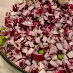 Add the red onions and peas to the top of the lettuce.