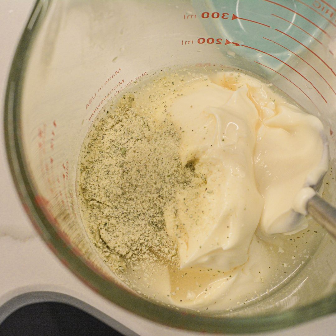 For the dressing, whisk together mayonnaise, sour cream, white wine vinegar, sugar, ranch seasoning, and black pepper until smooth and creamy.