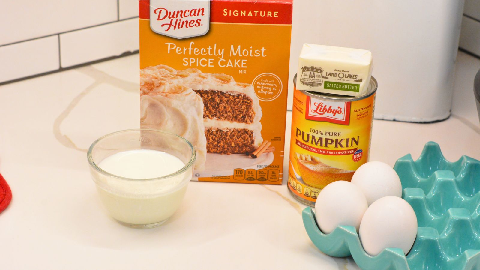 Pumpkin bars with cake mix ingredients of milk, pumpkin puree, eggs, butter, and spice cake mix.