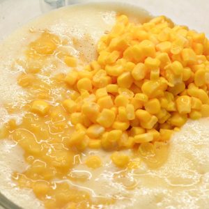 Combine All Ingredients: In a large bowl, add drained whole kernel corn, creamed corn, melted butter, beaten eggs, the cornstarch-milk mixture, and sugar. Stir until well combined. Season with salt and pepper to taste.