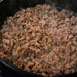 Brown the breakfast sausage in a skillet.