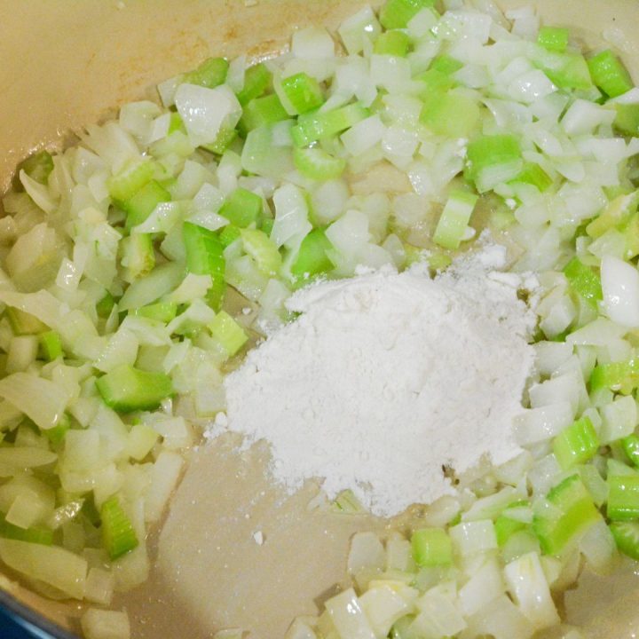 Prepare the sauce: Sprinkle the flour over the sautéed vegetables and stir well. Gradually pour in the chicken broth, whisking to form a thick, creamy sauce.