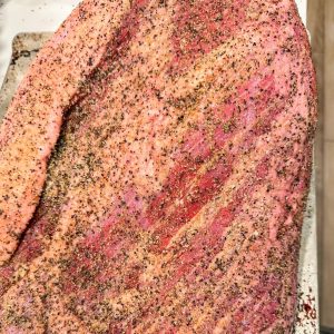 Trimming the Brisket & Seasoning it - Trim excess fat, leaving about ¼ inch. This allows the smoke to penetrate and the fat to render, keeping the meat moist. Generously apply your BBQ rub all over the brisket, ensuring even coverage.