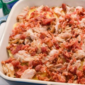 Top with the shredded chicken and crumbled bacon. Then sprinkle with half the shredded cheese.