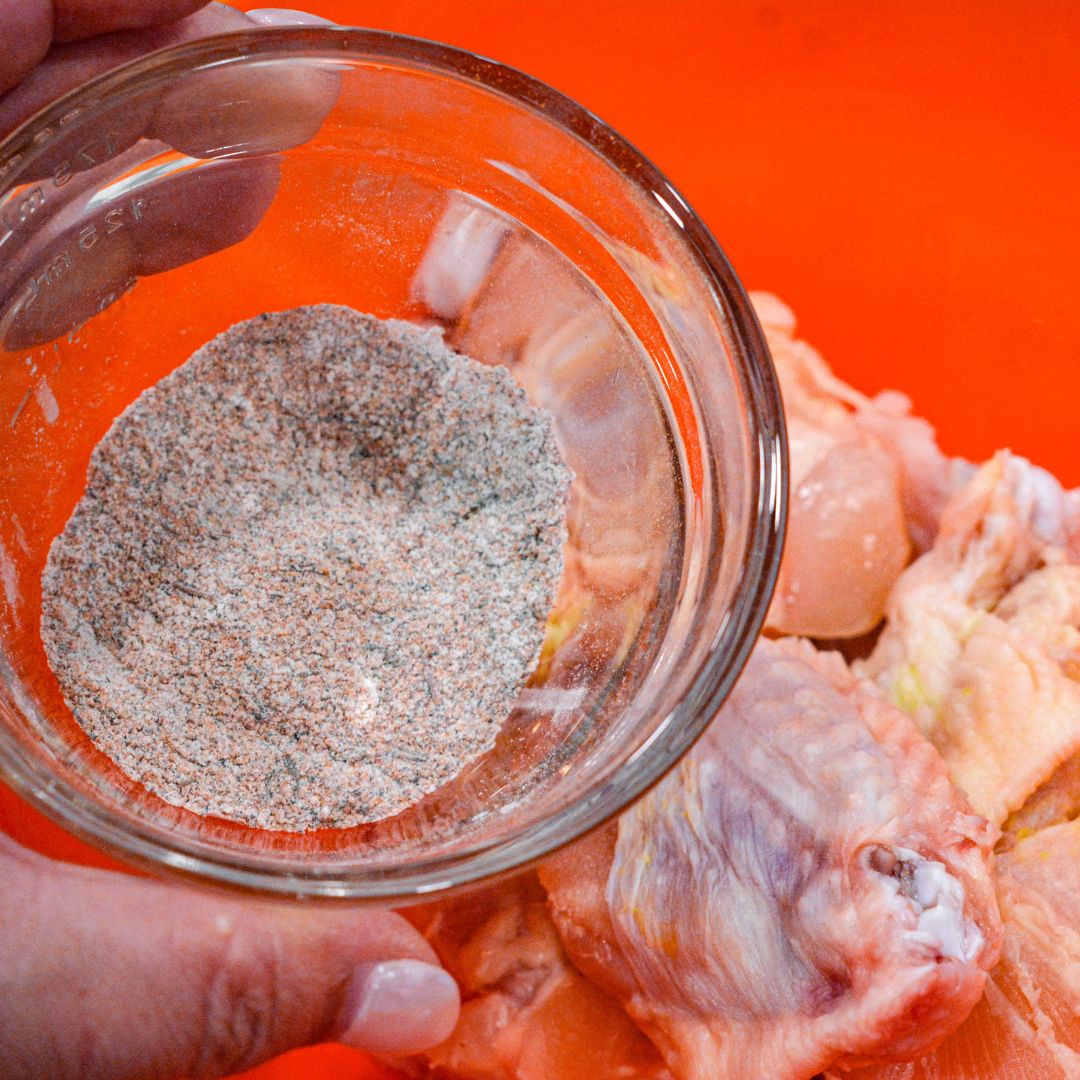 Combine your dry rub with the baking powder in a small bowl. Mix well, ensuring the leavening agent is evenly distributed.