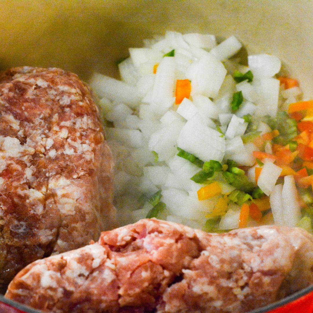 In a large pot or Dutch oven, brown the ground pork or sausage over medium-high heat, breaking it up with a spoon. Add the onion, bell pepper, and garlic to the pot. Sauté until the vegetables are softened, about 5-7 minutes. Drain any excess grease.