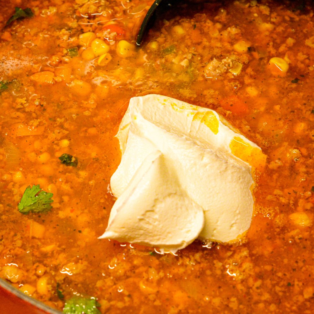 Once the chili is done, stir in the sour cream or Mexican crema.